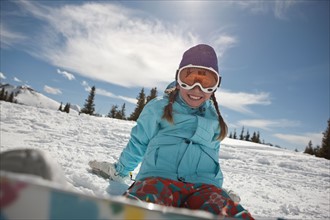 USA, Colorado, Telluride, Girl (10-11) posing with snowboard in winter scenery . Photo : db2stock