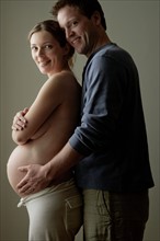 Studio portrait of expectant couple. Photo : Rob Lewine