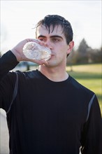 Portrait of man drinking water. Photo : Maisie Paterson