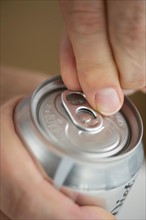 Man opening drink can.