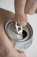 Man opening drink can.