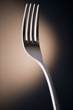 Close up of fork on black background. Photo : Jamie Grill Photography