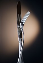 Close up of fork and knife on black background. Photo : Jamie Grill Photography