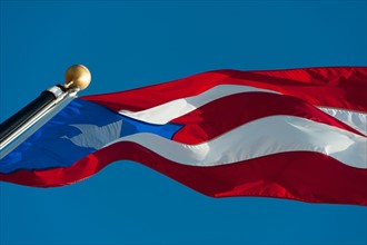 Puerto Rico, Old San Juan, Close up of Puerto Rican flag against blue sky.