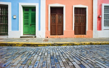 Puerto Rico, Old San Juan, door in houses on brick street.