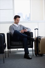 Businessman sitting in airport lounge.