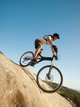 USA, California, Laguna Beach, Mountain biker riding downhill.