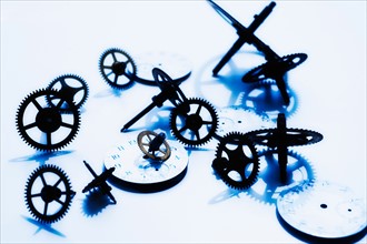 Close up of gears and clock parts on white background.