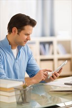 Man using digital tablet at home office.