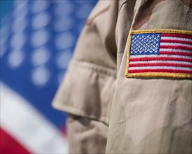 Close-up of badge with American flag on US military uniform.