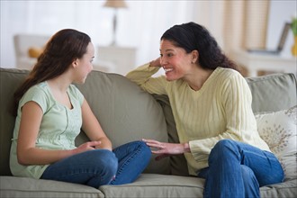 Mother talking to teenage daughter (14-15).