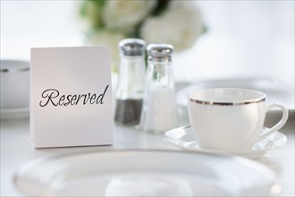 Close up of place setting with reserved sign.