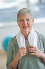 Portrait of smiling senior woman in gym.