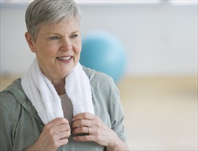 Smiling senior woman in gym.