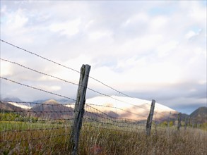 USA, Colorado, Mountain landscape with fence in foreground. Photo : John Kelly