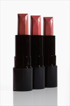 Studio Shot, Three pink lipsticks in row. Photo : Winslow Productions