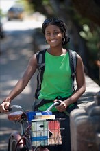 Portrait of female student with bicycle. Photo : Noah Clayton