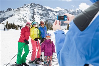 USA, Colorado, Telluride, Three-generation family with girl (10-11) posing during ski holiday.