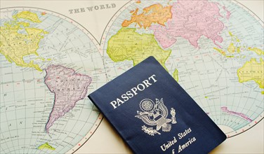 Close-up of passport lying on map.