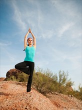 USA, Arizona, Phoenix, Young woman exercising on desert.
