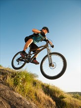 USA, California, Laguna Beach, Mountain biker jumping downhill on his bike.
