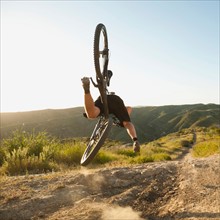 USA, California, Laguna Beach, Mountain biker falling of his bike.