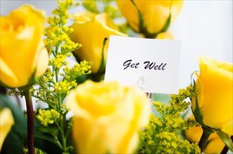 Get well card on bouquet of roses.