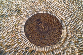 Greece, Rhodes, Manhole cover with symbol of Rhodes.