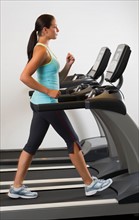 Woman walking on treadmill.