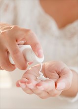 Close up of woman's hands applying moisturizer. Photo: Jamie Grill