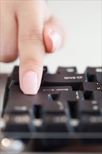Close up of woman's hand pressing enter key. Photo: Jamie Grill
