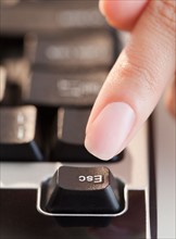 Close up of woman's hand pressing escape key. Photo : Jamie Grill
