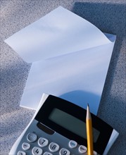 Calculator and blank paper. Photo : Daniel Grill
