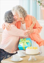 Two senior women celebrating birthday. Photo: Daniel Grill