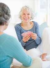 Two senior women playing cards. Photo : Daniel Grill