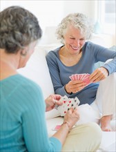 Two senior women playing cards. Photo: Daniel Grill