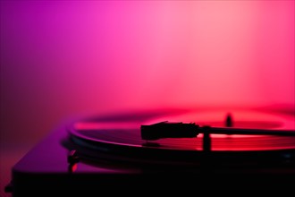 Close up of turntable on pink background. Photo : Daniel Grill