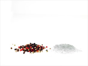 Studio shot of mixed pepper corns and coarse salt. Photo: David Arky