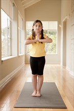 Girl (6-7) practicing yoga. Photo: Rob Lewine
