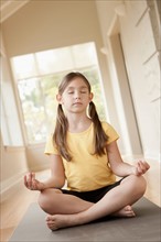 Girl (6-7) practicing yoga. Photo: Rob Lewine