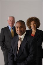 Portrait of three business people, studio shot. Photo: Rob Lewine