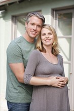 Portrait of pregnant woman with husband. Photo : Rob Lewine