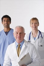 Portrait of three medical professionals, studio shot. Photo : Rob Lewine