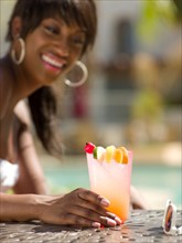 Young woman at pool side bar. Photo : db2stock