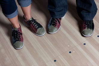Close-up of legs in bowling shoes at bowling alley. Photo: db2stock