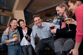 Group of people enjoying apres ski drink in bar. Photo : db2stock