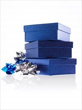 Stack of blue boxes with ribbons, studio shot. Photo: David Arky