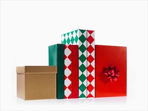 Four boxes with ribbon, studio shot. Photo : David Arky