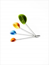 Studio shot of multicolored measuring spoons. Photo: David Arky