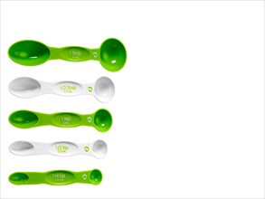 Studio shot of row of green measuring spoons. Photo : David Arky